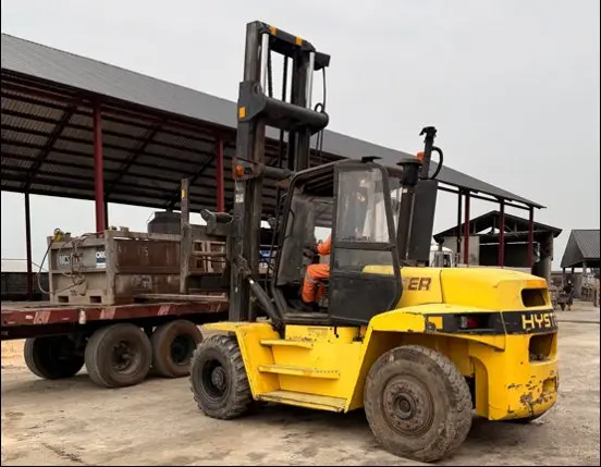 Forklift loading a waste skip